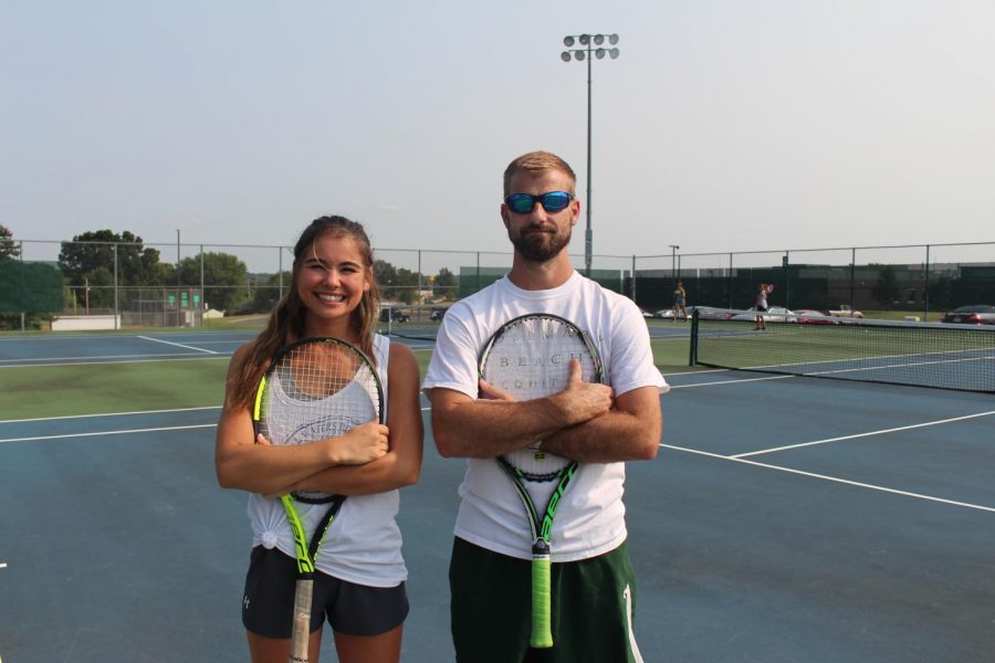 New assistant coach Emily Parr poses for a picture with head coach Justin Hoffman on the De Soto High School tennis courts on Sept. 1.