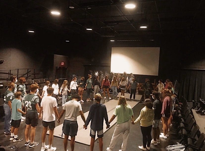 Fellowship of Christian Athletes attendants participate in the circle prayer to mark the end of a meeting at De Soto High School on Sept. 3, 2021. 