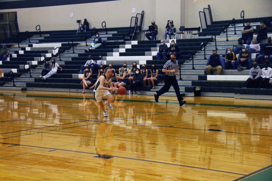 Senior Sadie Carver drives towards the basket in a game during the 2020-21 season 