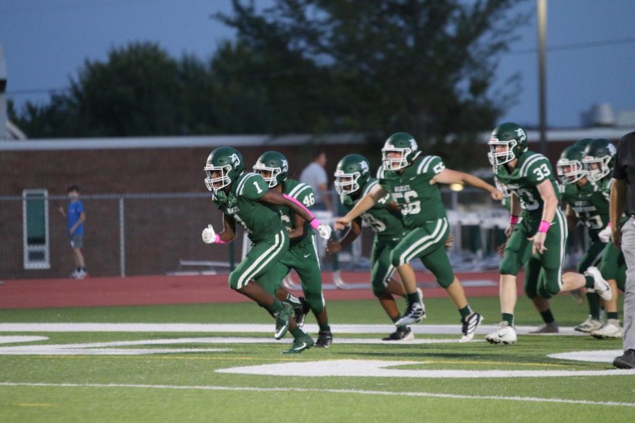 The DHS football team runs onto the field before their game against Piper High School on Oct. 8.