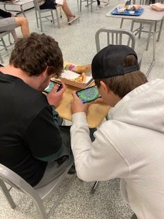 Seniors Landon Reith and Hoover O'Bannon intensely compete in a clan war in the De Soto High School student union on Dec. 2. 