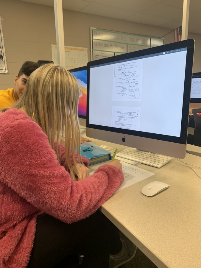 Junior Carson Schuman reviews her pre-calculus study guide in preparation for her upcoming final.