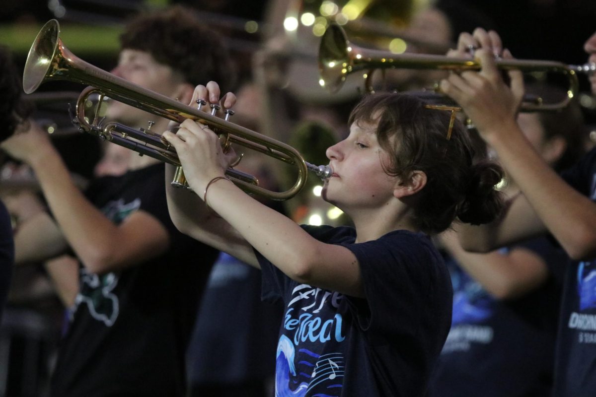 Junior Maddy Mosbaek plays trumpet during "Hoist the Colors."